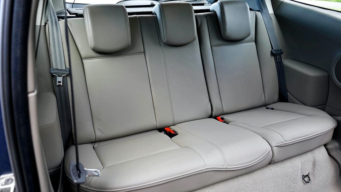 An empty child car seat installed in the back of a vehicle