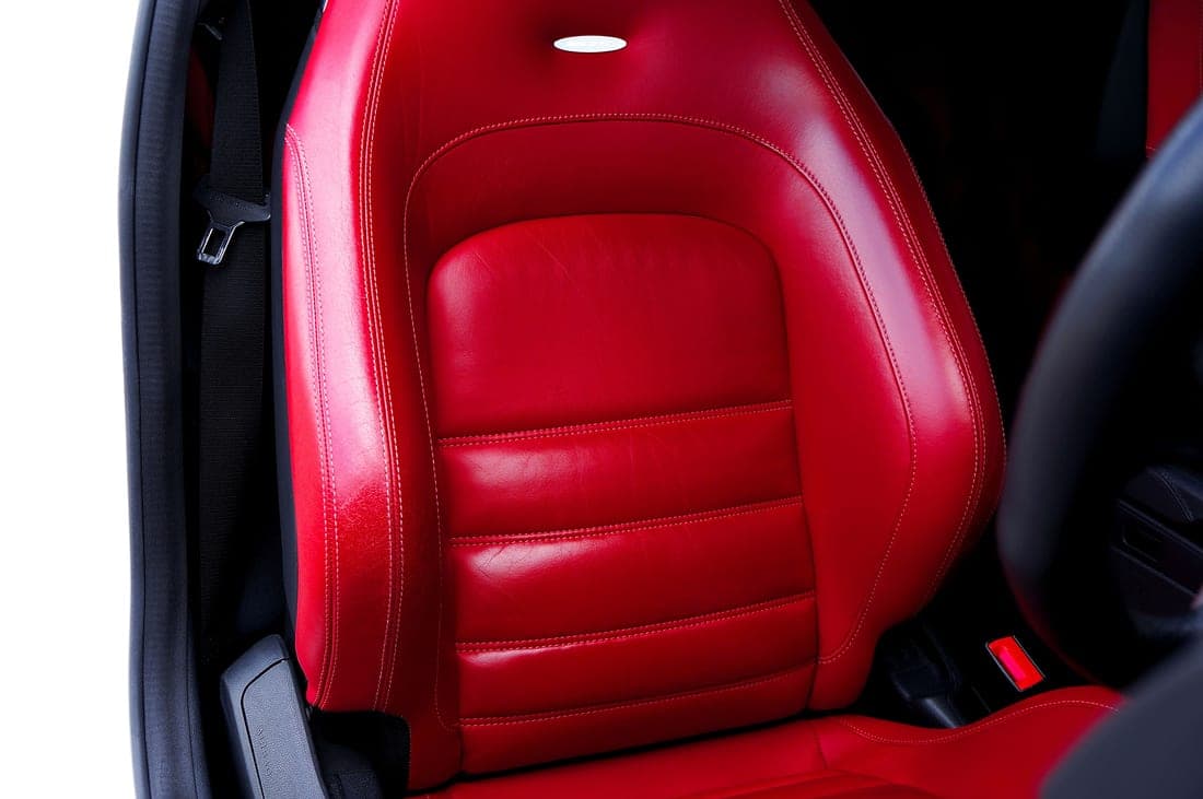 Vehicle seat upholstery beneath a child car seat