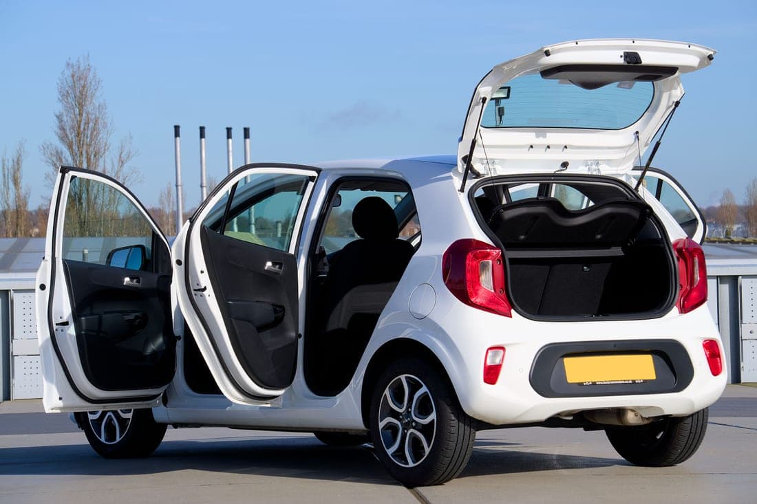 A car seat installed in the back of a compact car