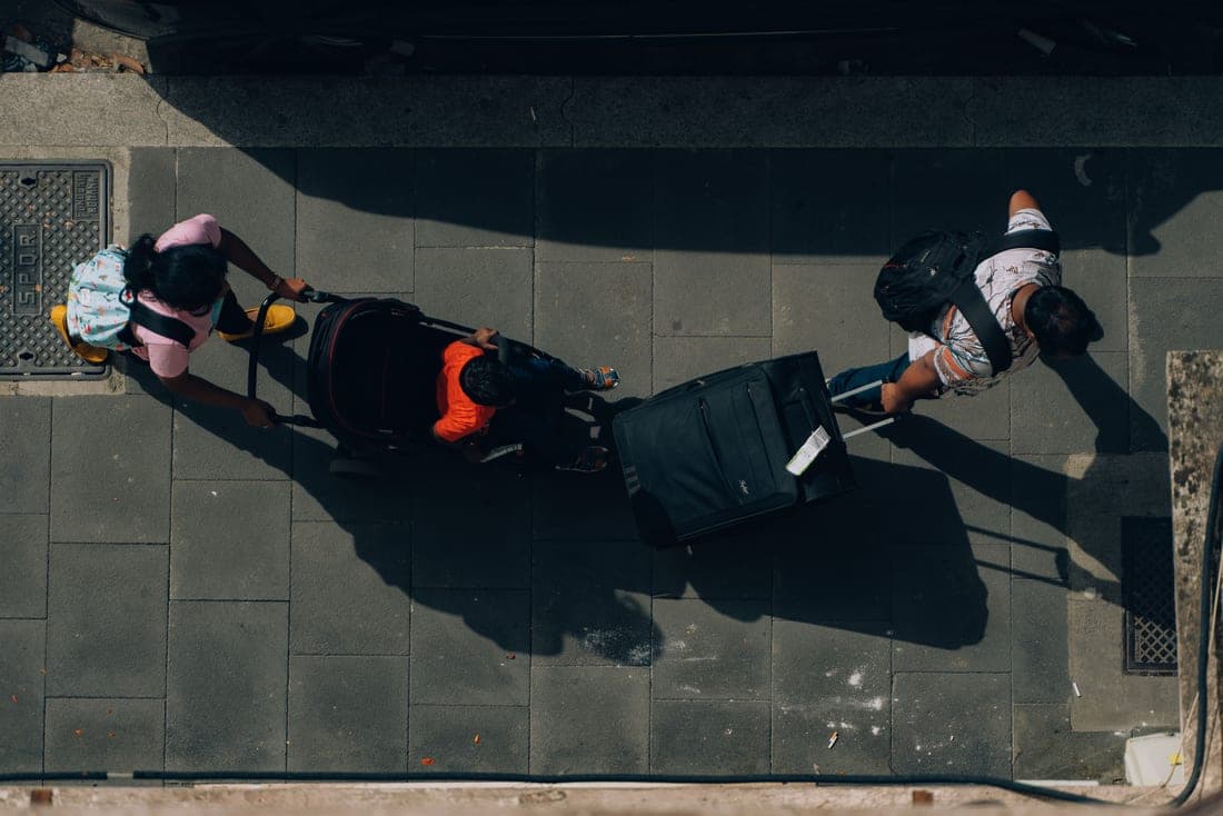 Two compact strollers folded beside one another