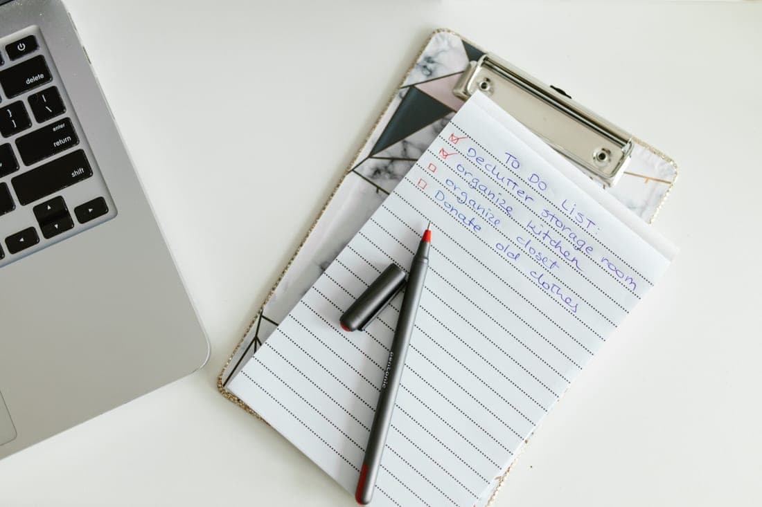 A printed checklist on a clipboard beside a child car seat
