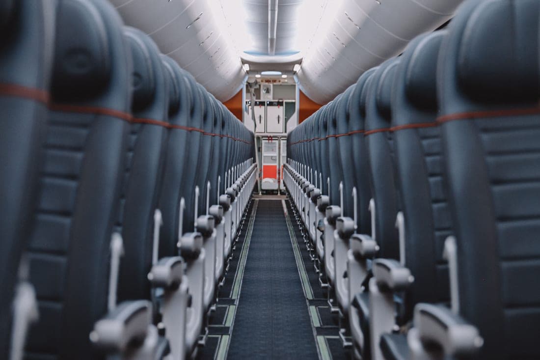 An aircraft cabin with rows of seats