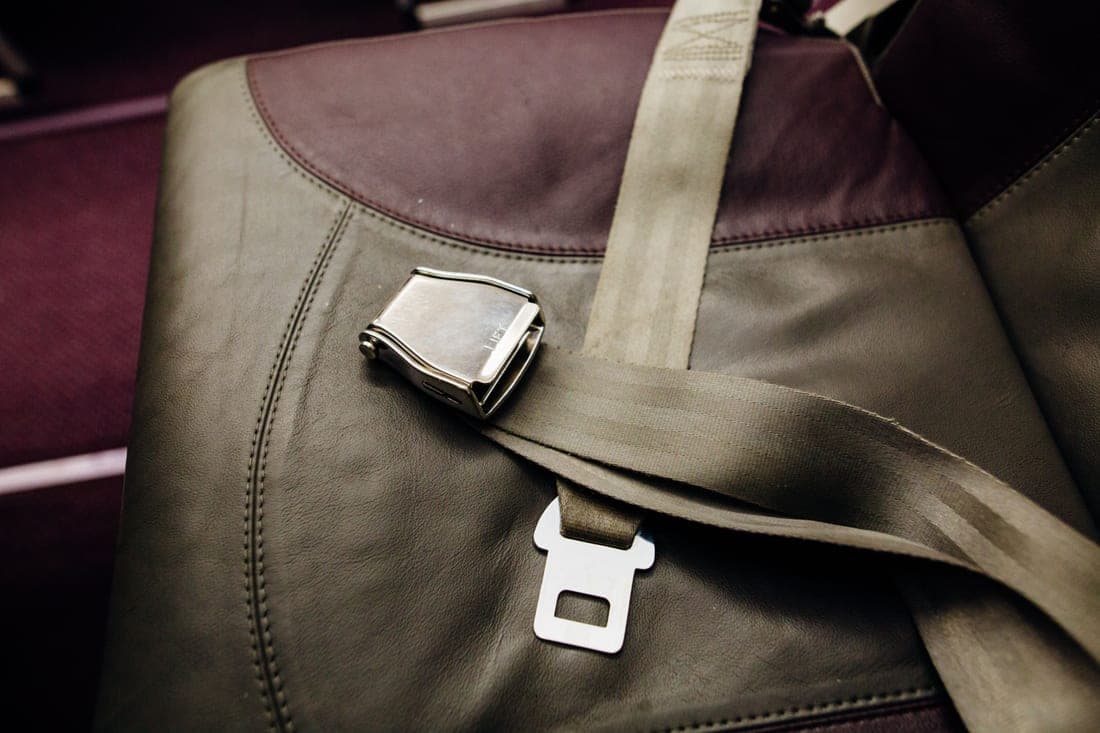 A harnessed car seat and a booster seat side by side