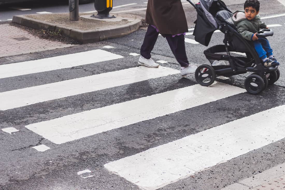A folding car seat stroller beside a conventional travel system