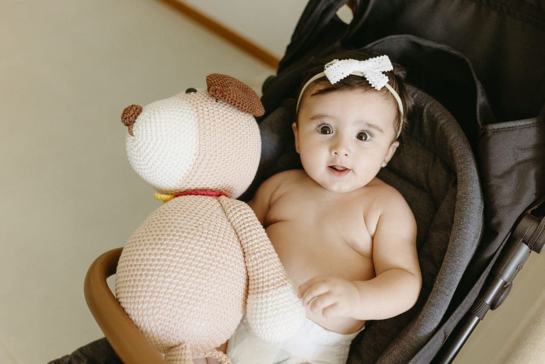 An infant car seat attached to a stroller frame