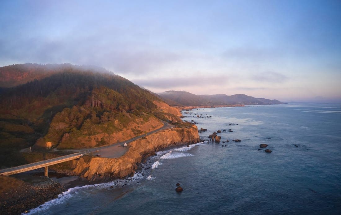 A California highway with a car traveling on it
