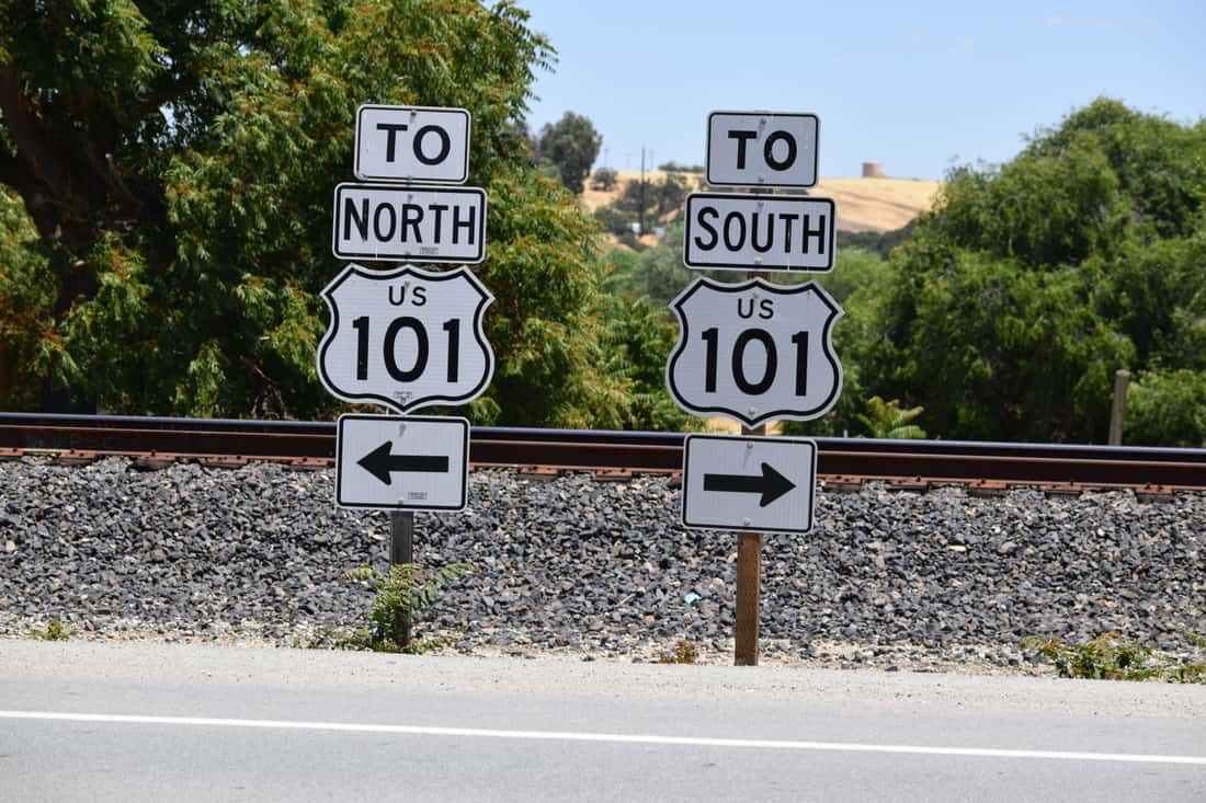 A car on a US highway with state signage