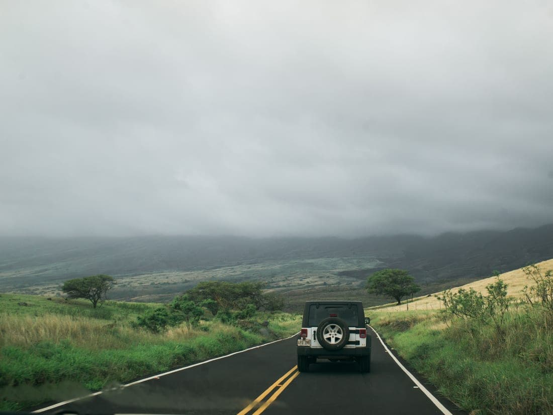 A car packed for a road trip on an open road