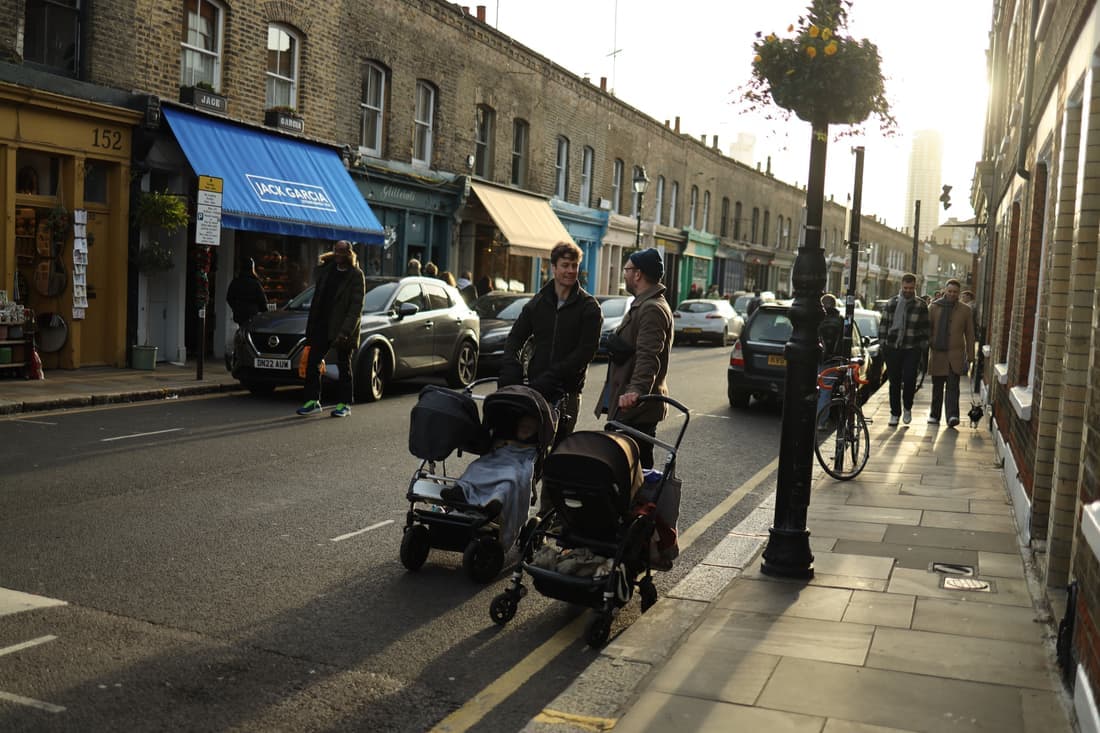 Two full-size strollers parked side by side