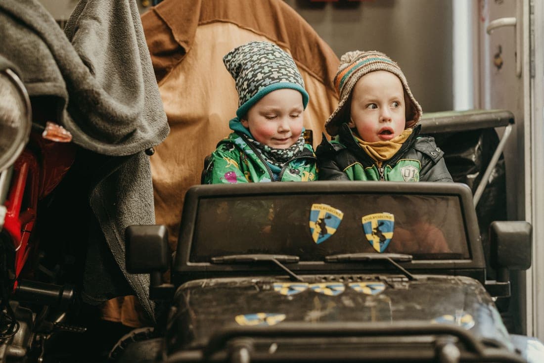 A child being buckled into a car seat