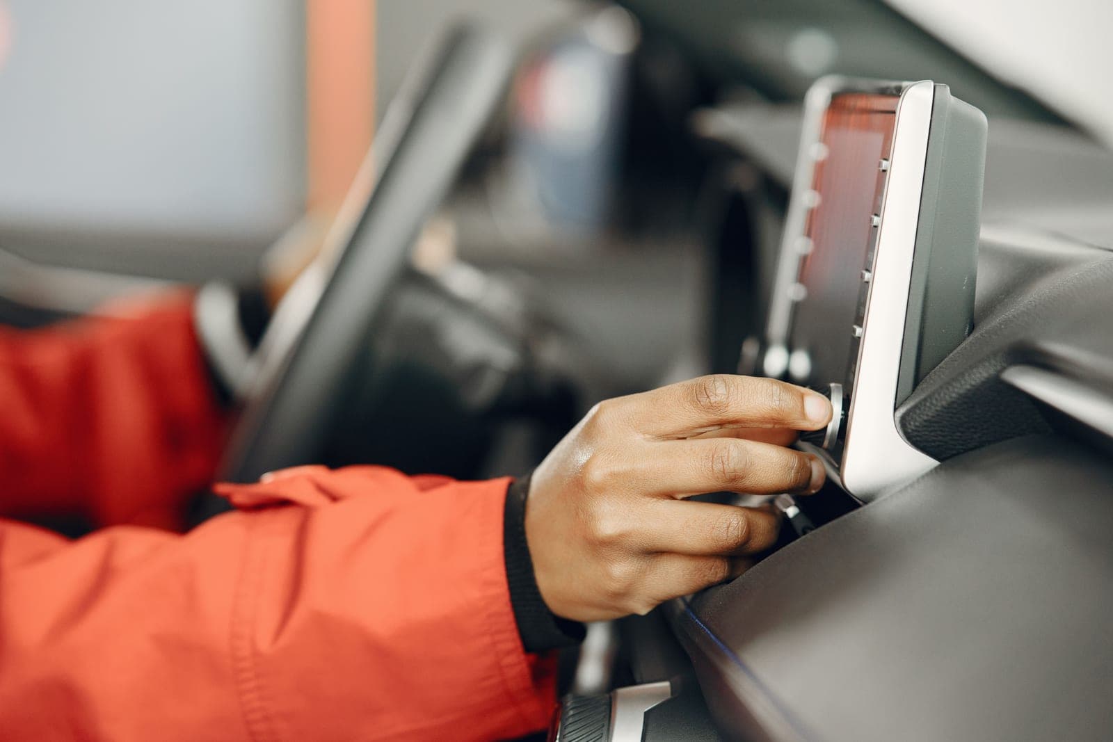 An adult checking a child car seat installation