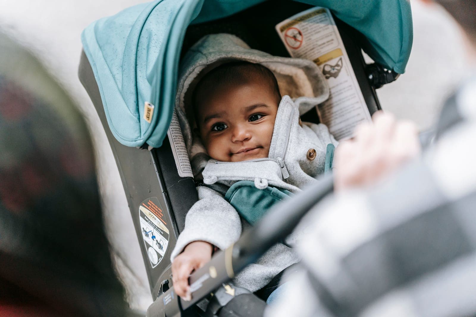 An infant car seat attached to a stroller frame