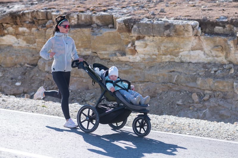 A parent running with a jogging stroller — category photo, not this specific model