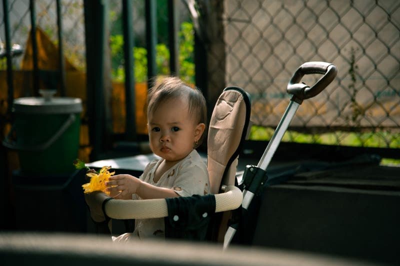 A toddler in a lightweight umbrella stroller — category photo, not this specific model