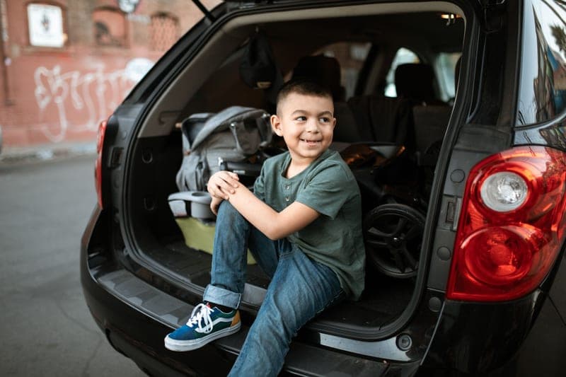An older child seated in the back of a car — category photo, not this specific model